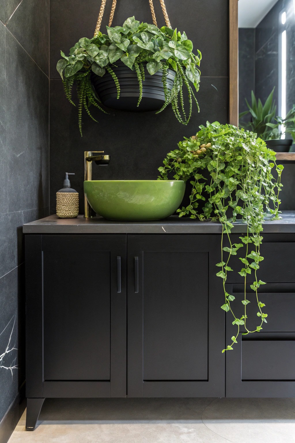 A bold emerald planter brings joyful energy to a chic black bathroom.