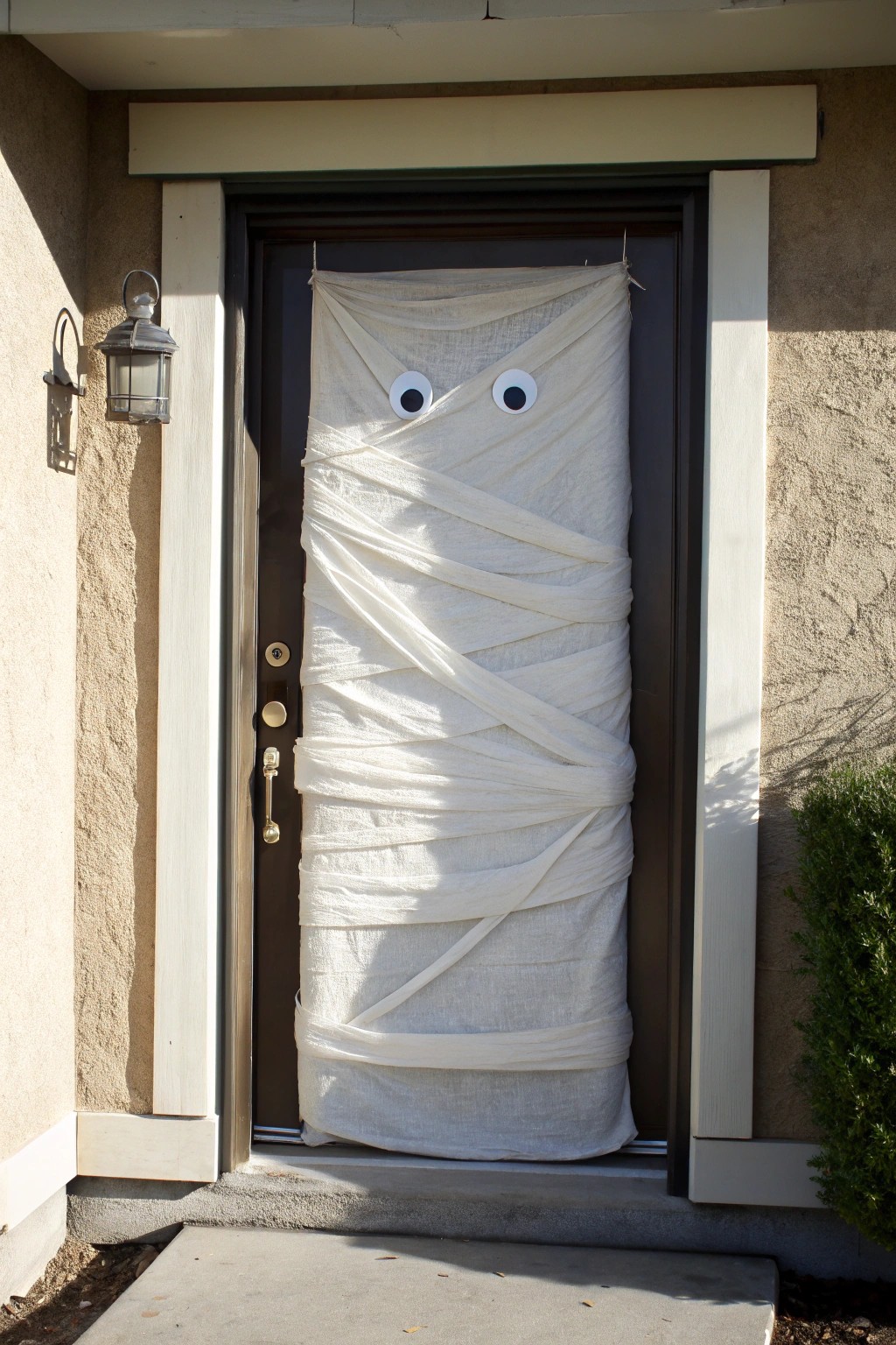 Transform your entryway with a simple and stunning mummified door wrap for Halloween.