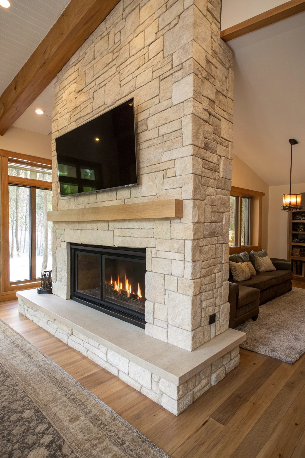 Effortless style: a double-sided fireplace wall with TV blends warmth and modern craft.