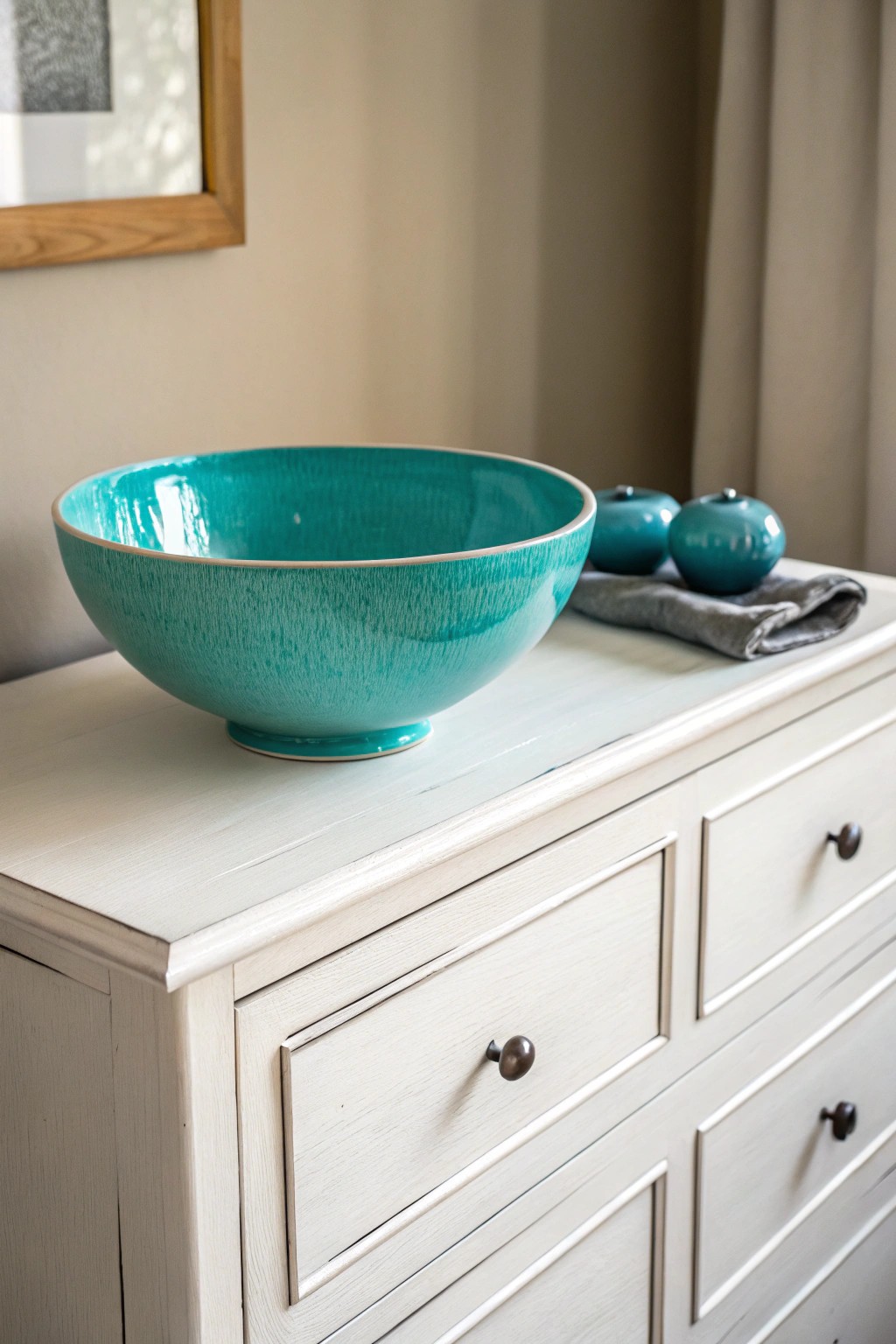 A pop of teal transforms a simple dresser into a stunning focal point.