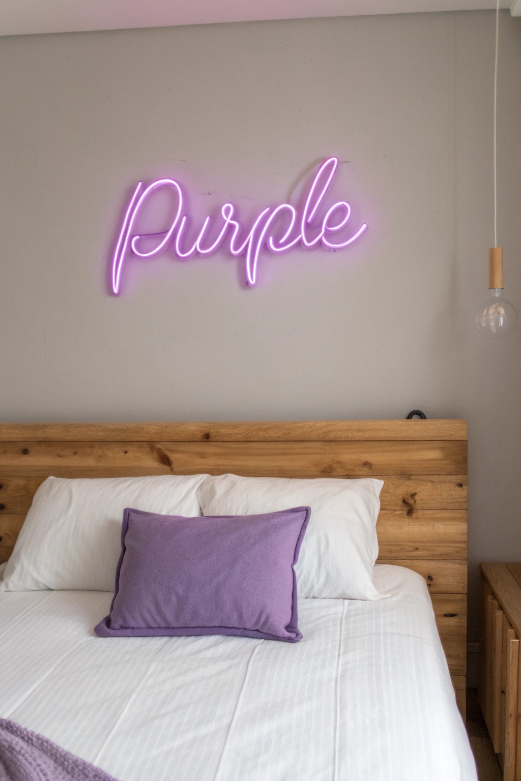 A custom purple neon sign adds playful charm and handcrafted elegance to a serene bedroom retreat.