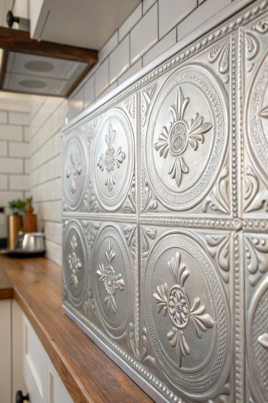 Elevate your kitchen with the timeless charm of a pressed tin backsplash.