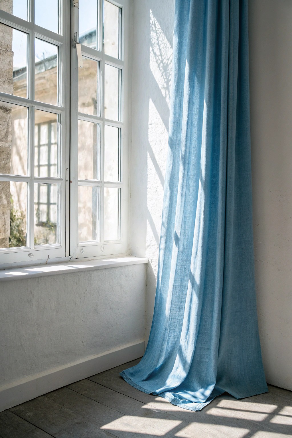 Subtle blue curtains: framing light with natural elegance.