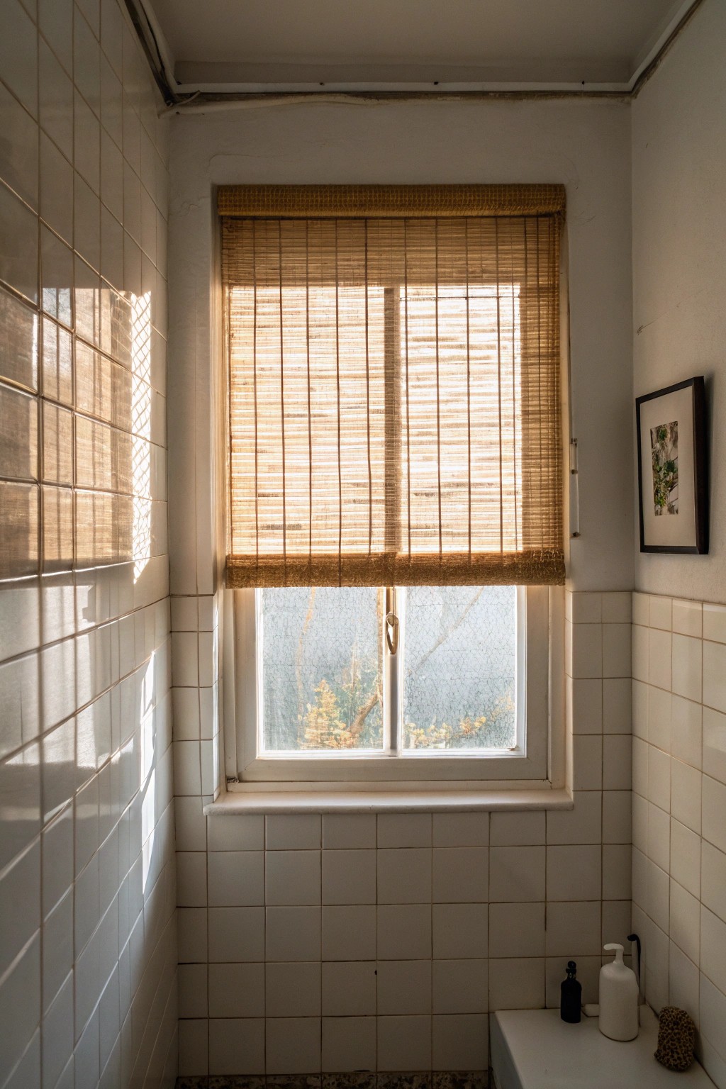 Let in soft daylight with translucent bamboo shades—privacy and natural beauty for small bathrooms.