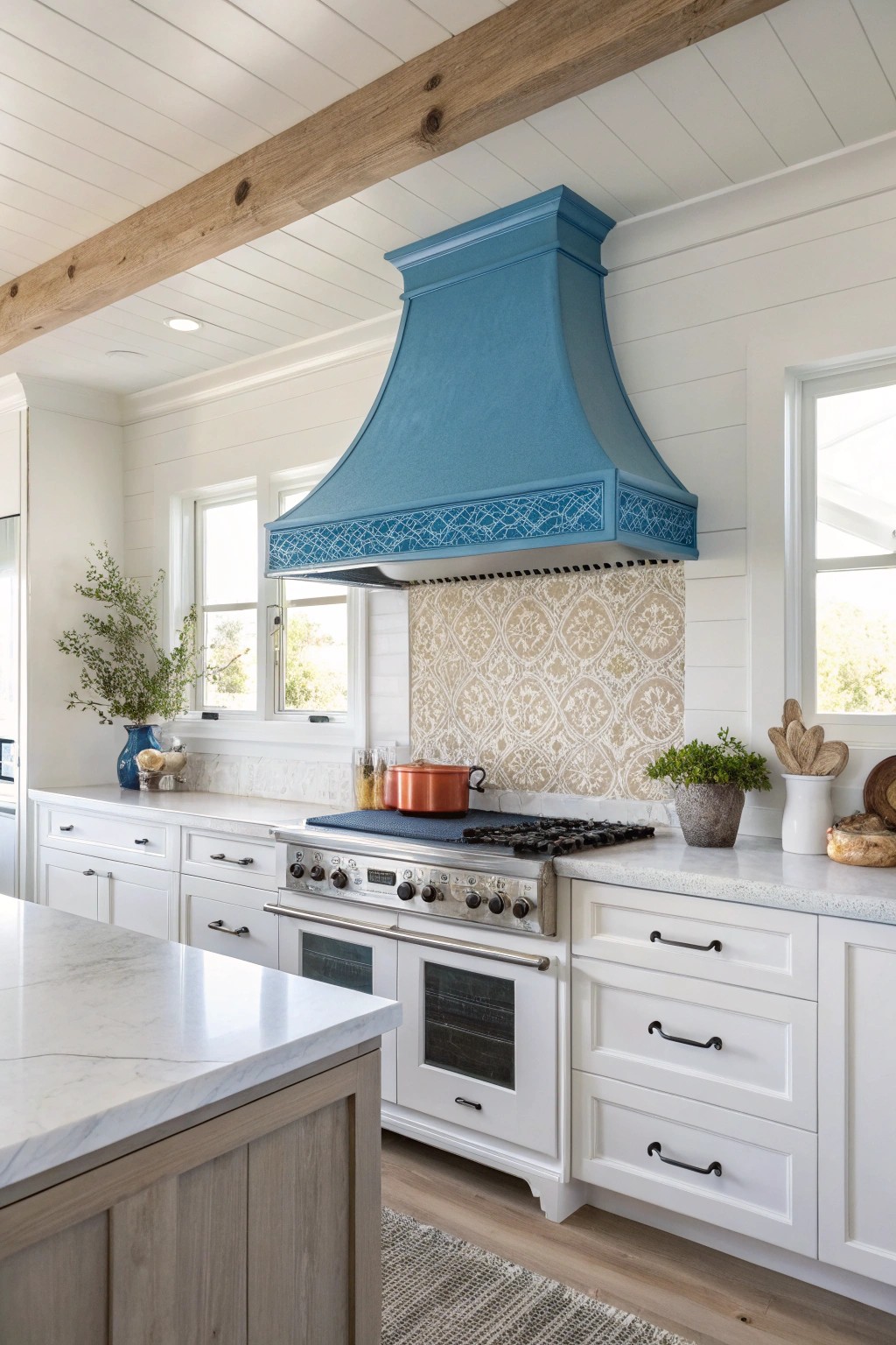A bold blue range hood brings playful sophistication to this serene coastal kitchen.