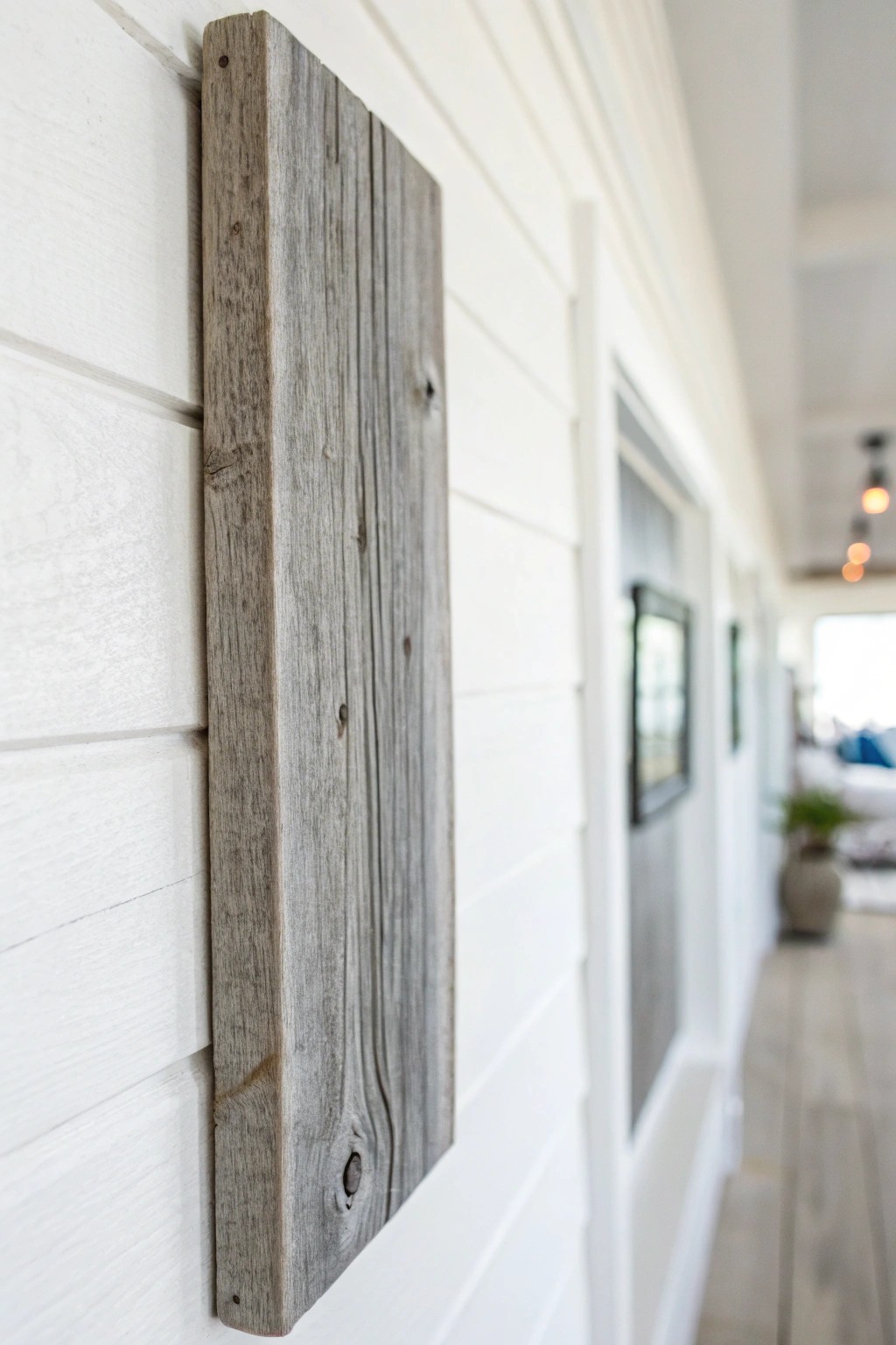 Elegant simplicity: a weathered gray wood accent plank brings breezy coastal charm to any space.