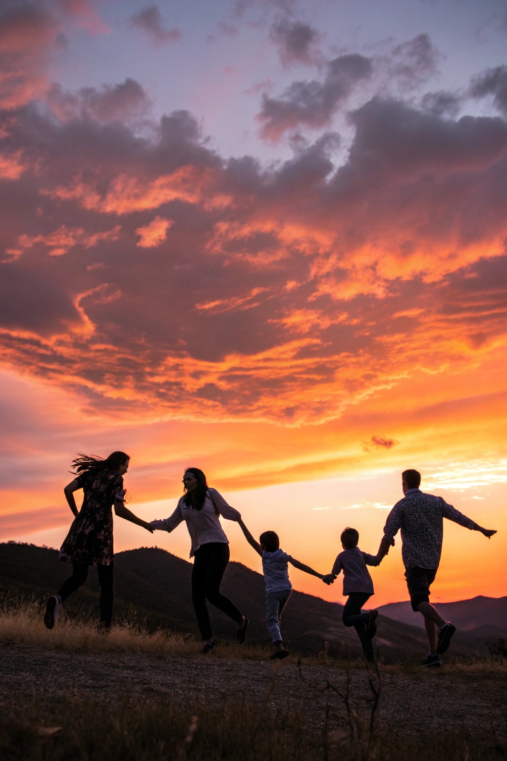 A striking silhouette of a family celebrating together at dusk.