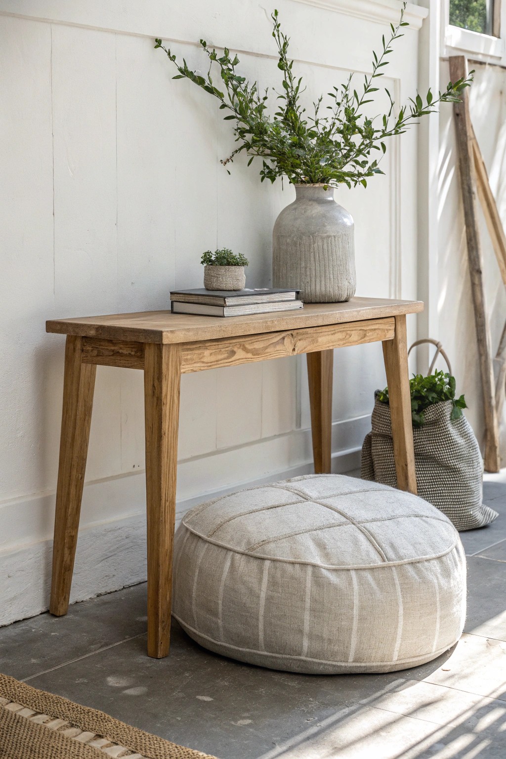 A cozy pouf under the entryway table—simple, beautiful, and always ready for guests.