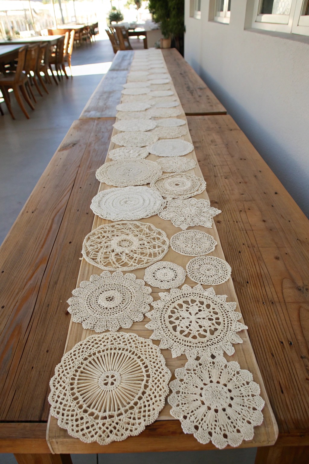 Layered vintage doilies create a dreamy, handcrafted table runner centerpiece.