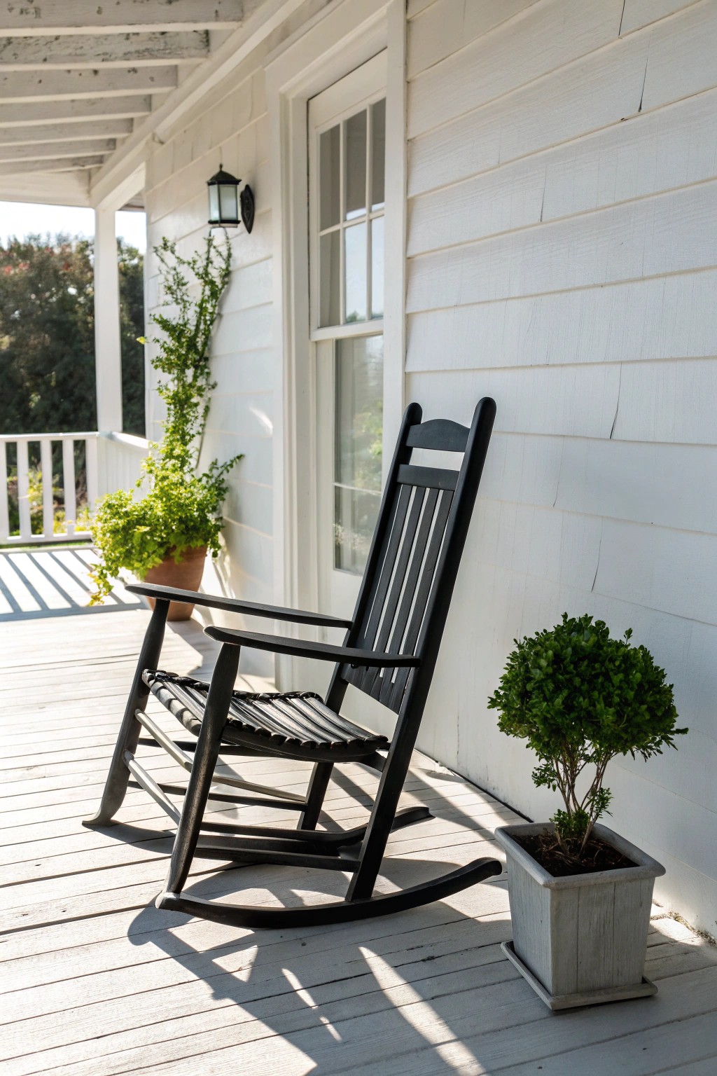 Bold simplicity: a black rocking chair makes a striking statement on a crisp white porch.