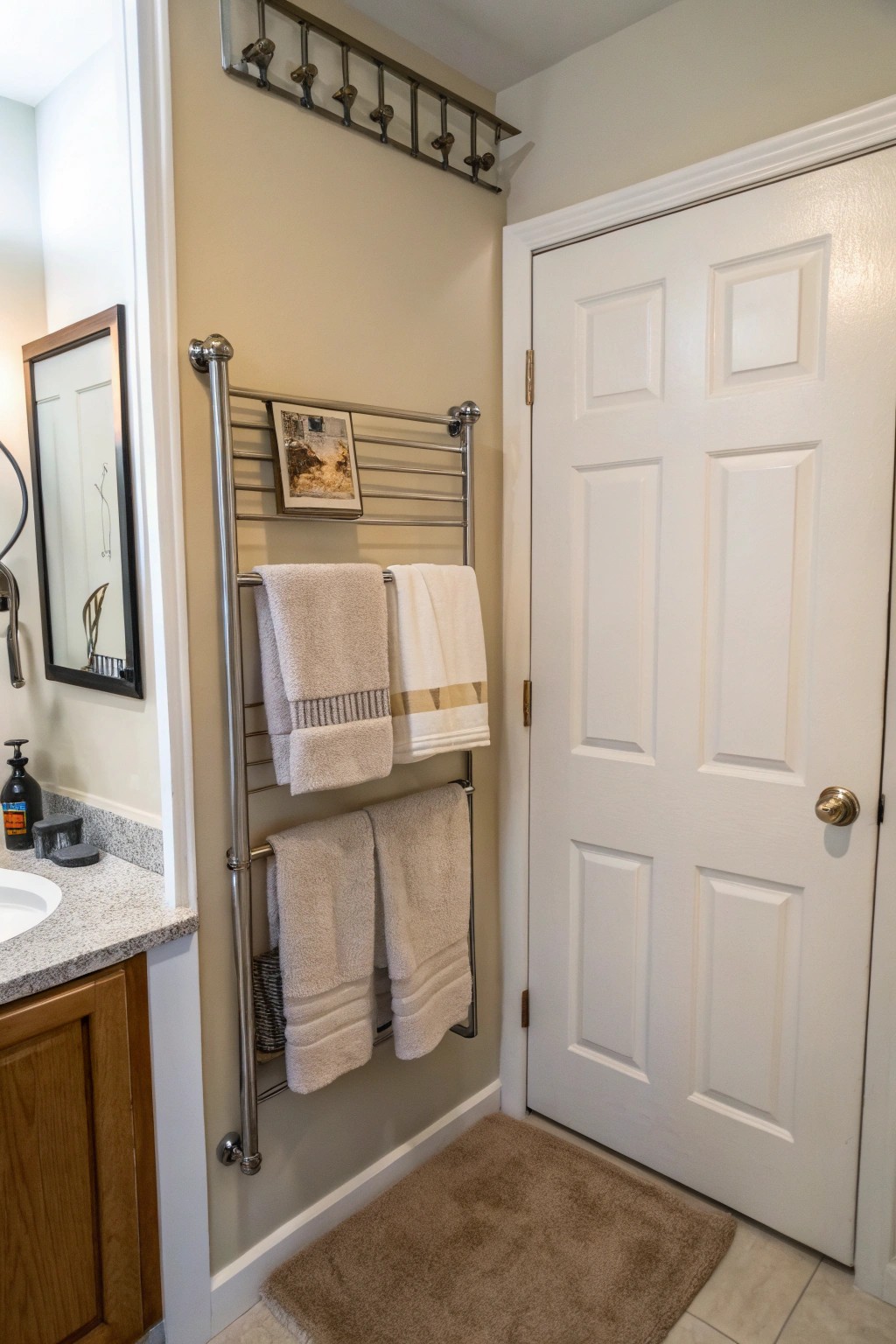 A towel rack above the door makes use of hidden vertical space.