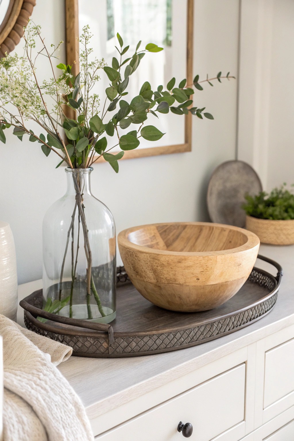 Layer glass, wood, and metal for dresser decor with natural depth and timeless style.