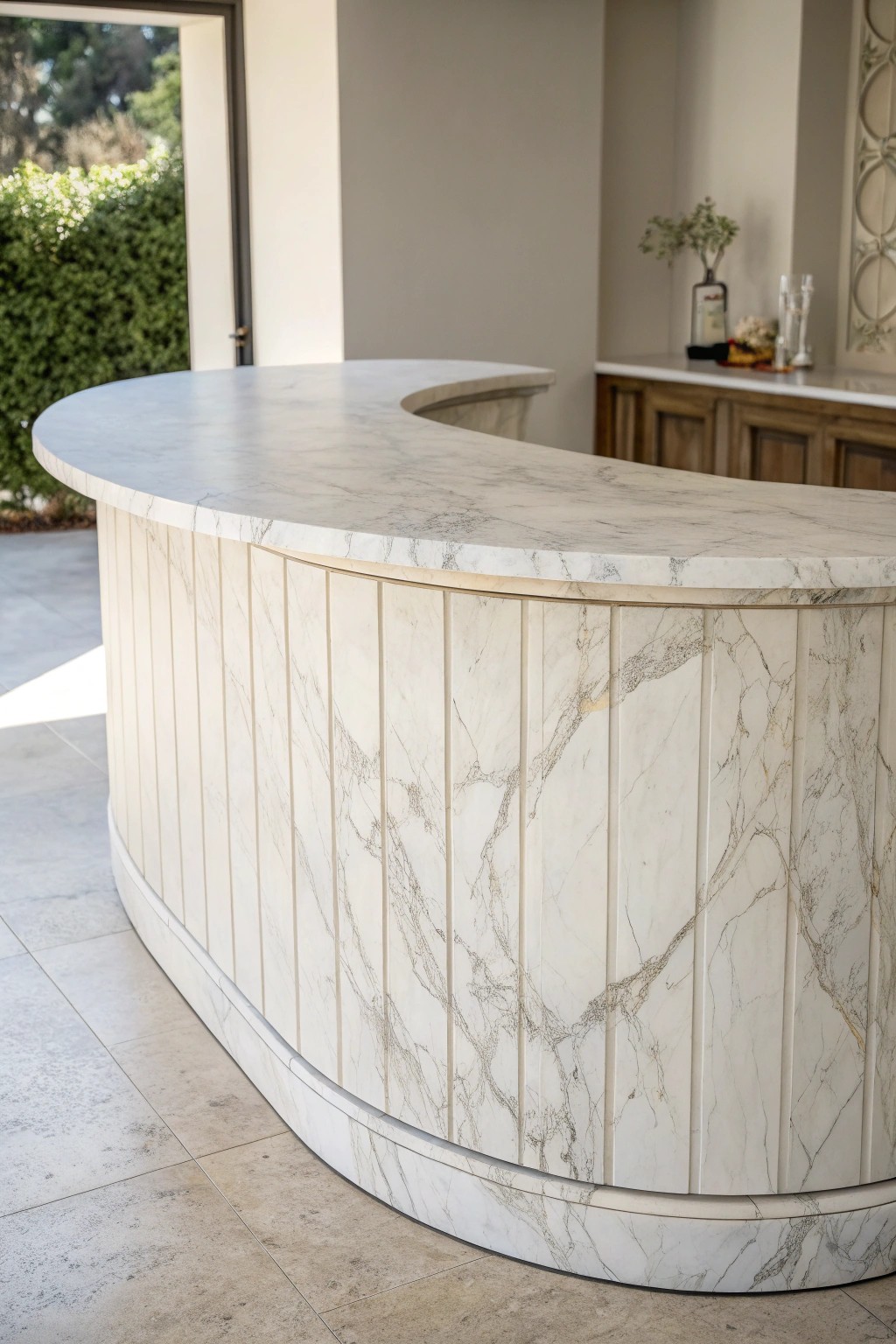 Elevate your bar with the timeless elegance of a curved marble countertop.