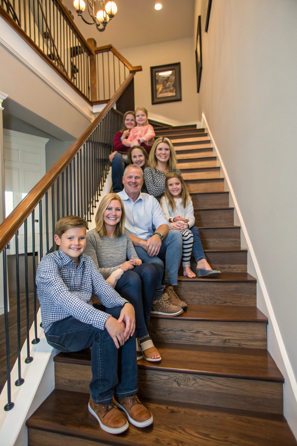 Family members positioned on stairs, creating a dynamic, multi-level portrait.