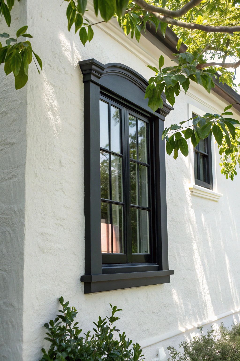 A bold black window trim transforms a simple facade into a modern masterpiece.