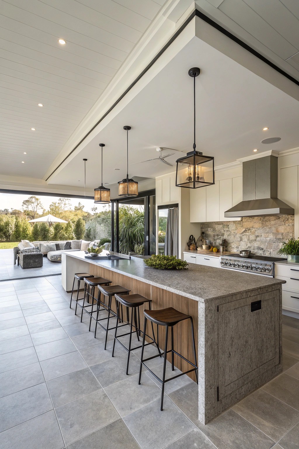 A central kitchen island with comfortable seating becomes the heart of open kitchen living.