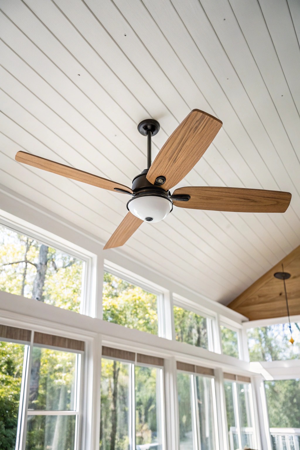 Elevate your three-season room with a stunning statement ceiling fan—where cool comfort meets artful design.