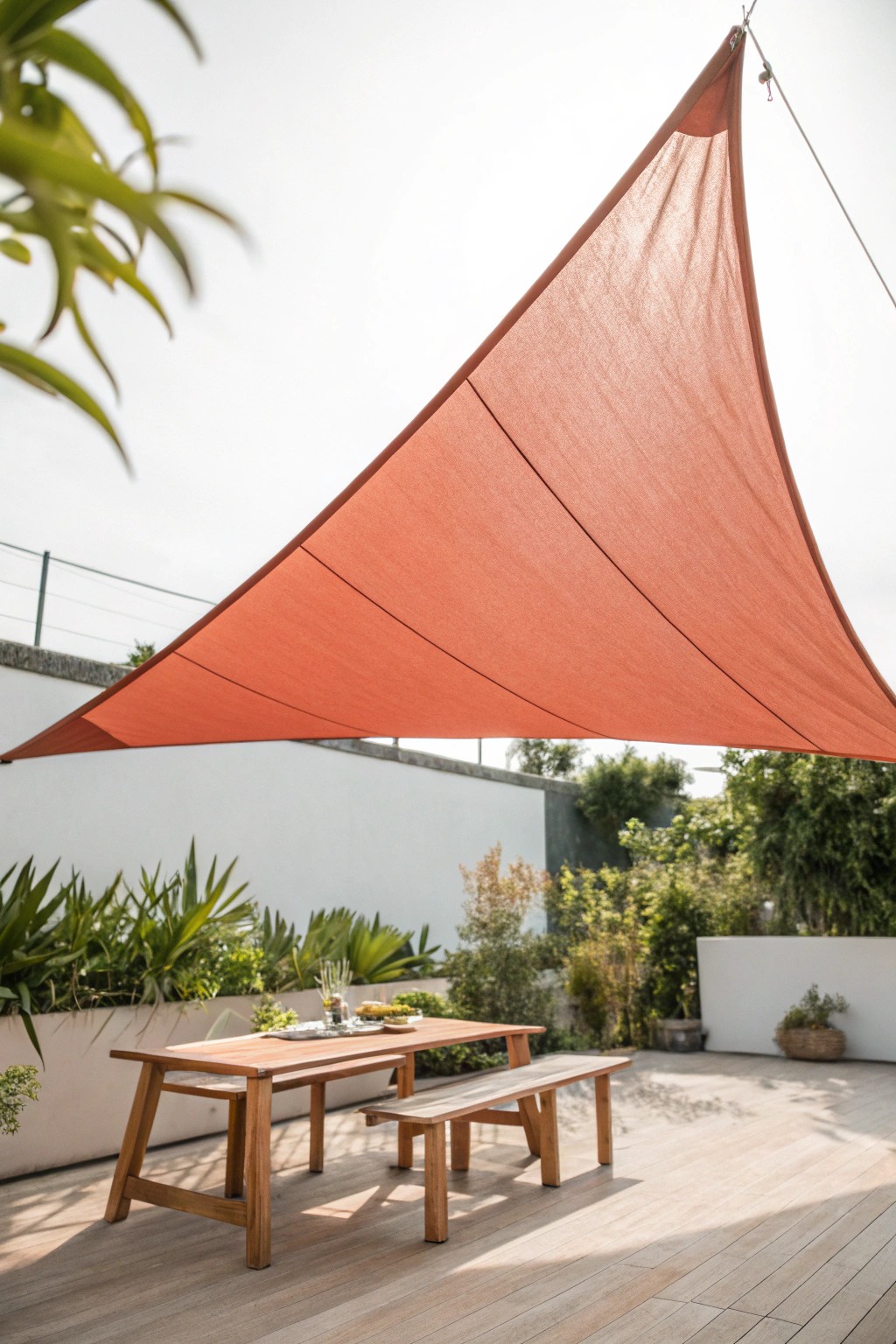Elevate your patio with a simple, colorful shade sail—affordable style meets natural beauty.