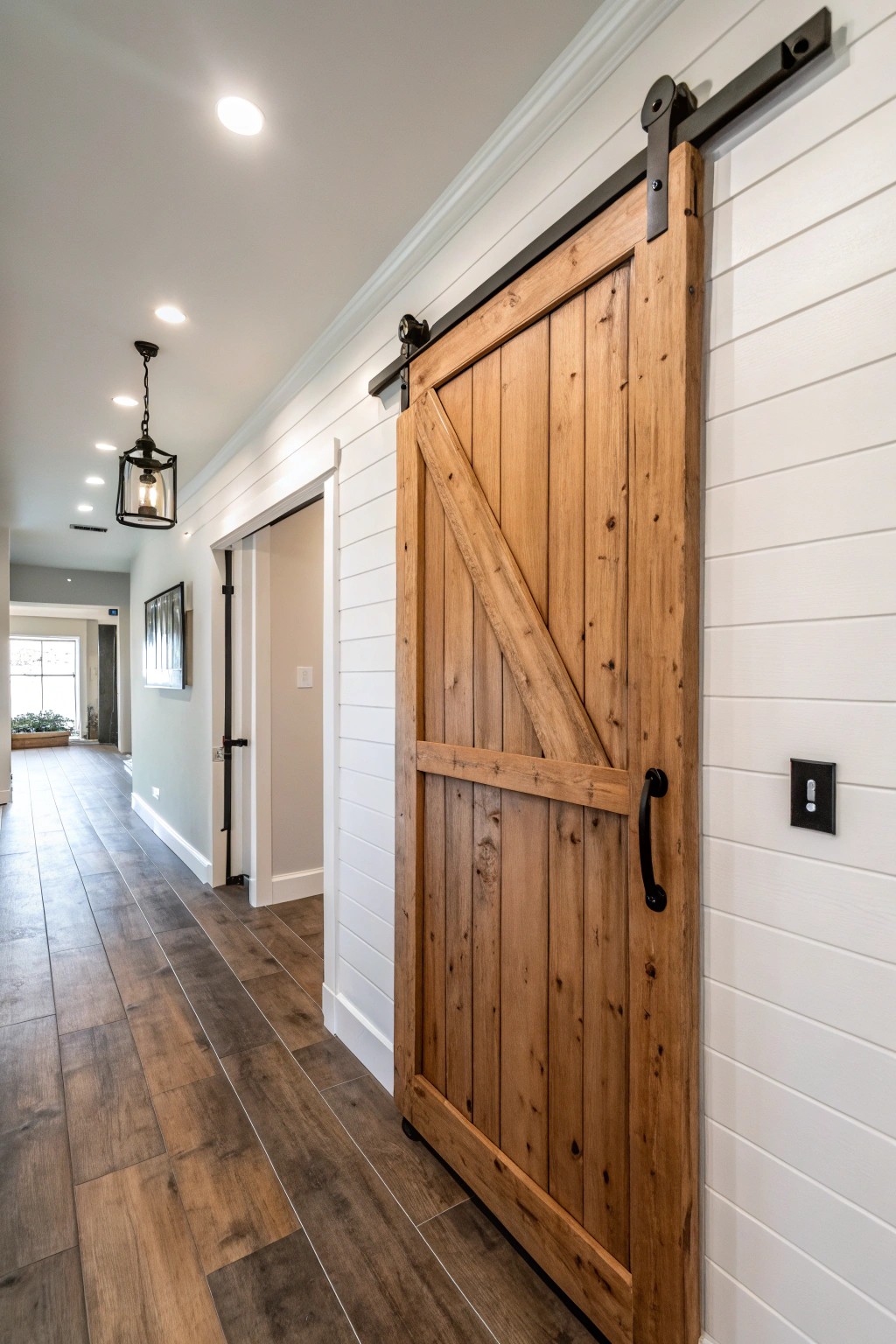 A striking sliding barn door adds rustic charm and smart function to the space.