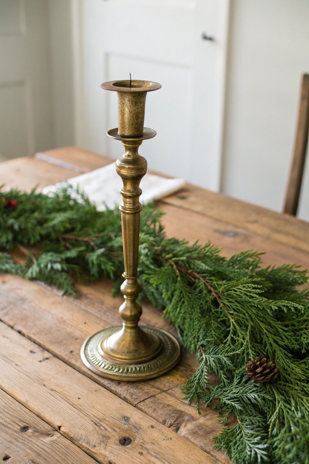 Classic elegance: Vintage brass meets lush evergreens for a stunning Christmas centerpiece.