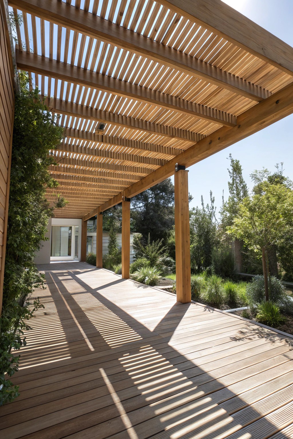 Let sunlight dance—embrace simplicity with a modern open-slat pergola.