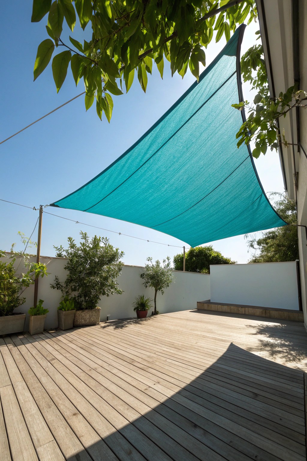 Add a pop of color and instant style with a bold turquoise shade sail.